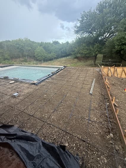 Rebar tied in a grid with forms set around the pool