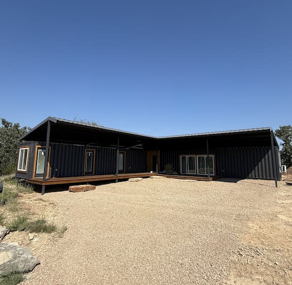 Covered porch with sliding glass doors at the finished container retreat