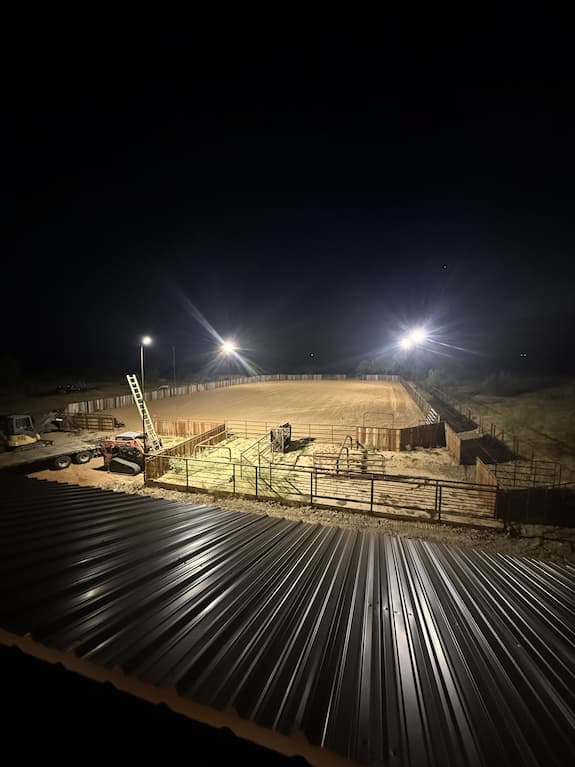 Riding arena lit at night with arena lights on