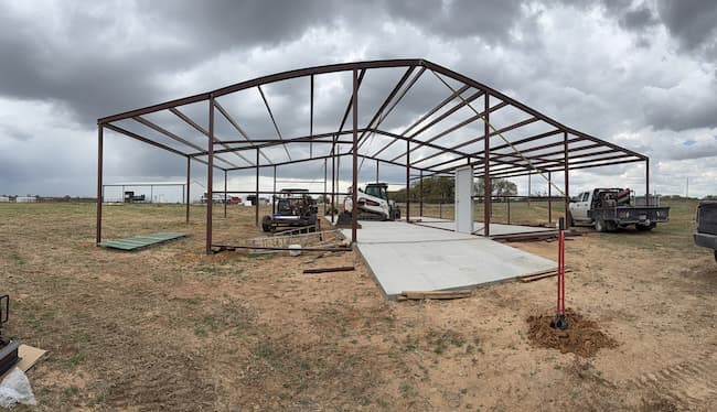 Steel frame of the barn standing before the roof goes on