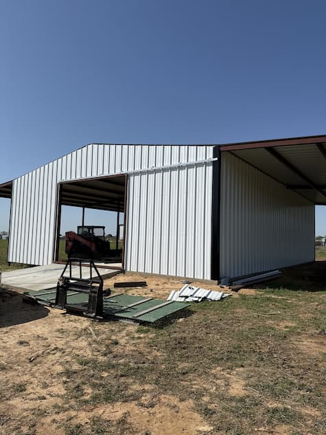 White wall panel partially installed on the barn