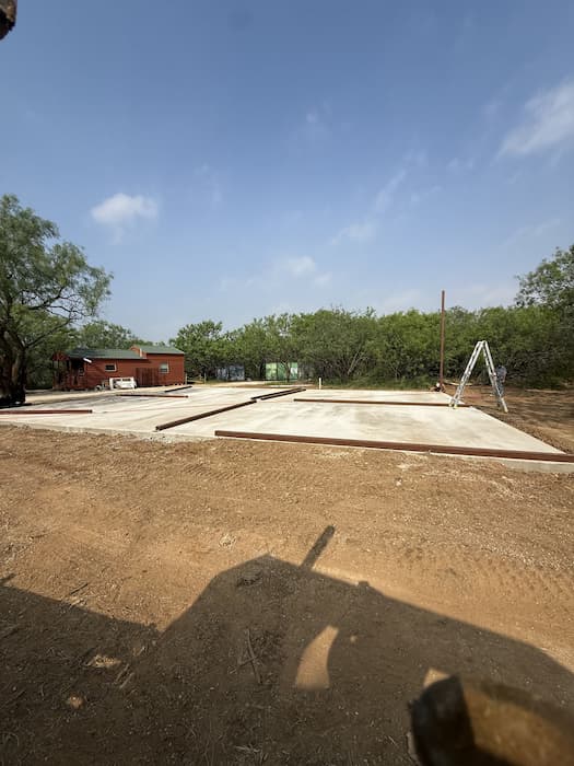Concrete slab poured with steel columns set for an RV cover