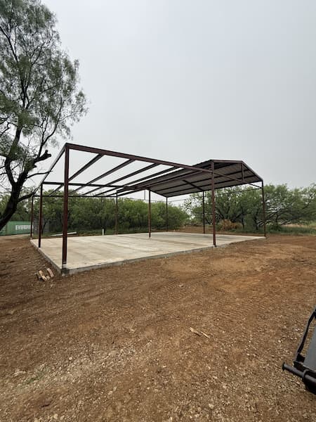 Open steel frame of the RV cover standing on the slab