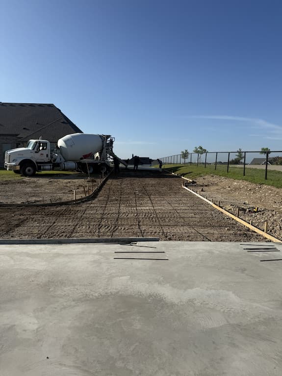Rebar tied and forms set for a concrete drive with the truck pouring