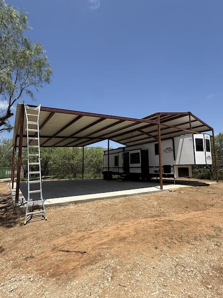 Finished RV cover with a fifth wheel parked underneath